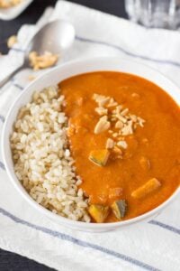 African Peanut Soup is served in the bowl on the white towel with tablespoon | Hurry The Food Up
