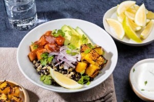 Burrito Bowl is ready for munching served with greek yogurt, lemon wedges, cilantro and fried tofu on the side | Hurry The Food Up