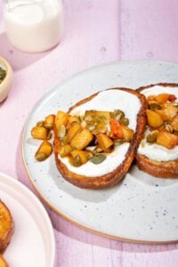 A plate with two slices of healthy French toast with apple and pumpkin seed mixture and cream cheese. | Hurry The Food Up