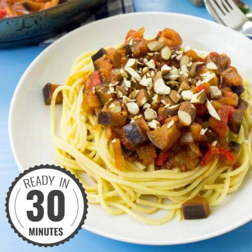 A plate of pasta arrabbiata on a blue surface with a time stamp in the bottom left hand corner | Hurry The Food Up