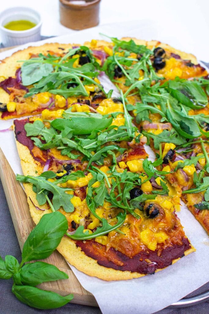 The pizza is served on the paper on a chopping board on a towel with olive oil, salt and basil #salt #tomato paste | hurrythefoodup.com