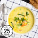 A bird’s eye view of a bowl of chowder, sprinkled with green onions, on a checked kitchen towel with a time stamp in the bottom left hand corner | Hurry The Food Up