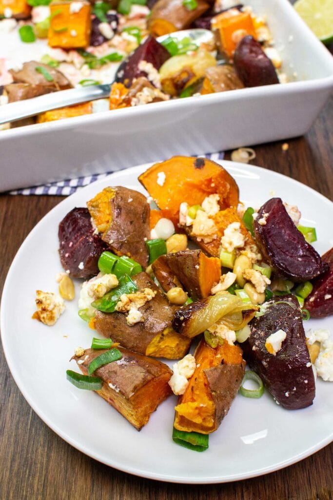 The dish is served on the plate with the baking tray with spoon on a towel with lime on the table #lime #peanuts | hurrythefoodup.com